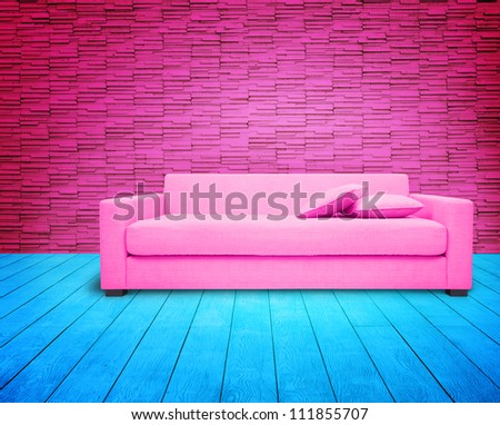 pink living-room with pink sofa on blue floor.