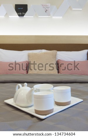 ceramic tea set decorated on bed.