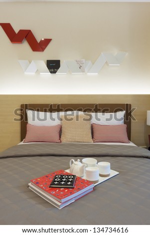 tea set and books decorated on bed.