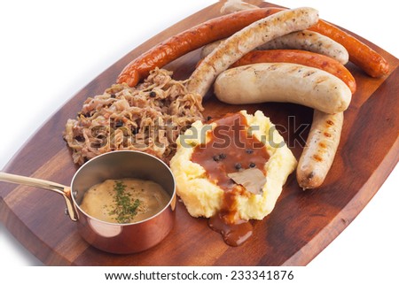 Grilled Mixed sausage served with infuse red cabbage mashed potato with gravy and mustard sauce,  on white.