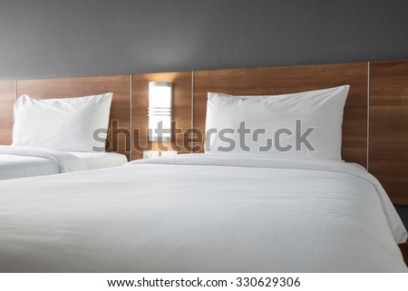 Twin bed with wood headboard.
