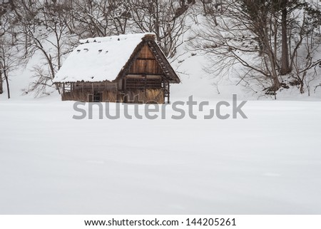 an isolated cabin located in a snow field