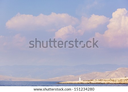 Solitary light beacon on island Rab, with distant view on mountain Velebit. Whole scene is in gentle pastel colors.