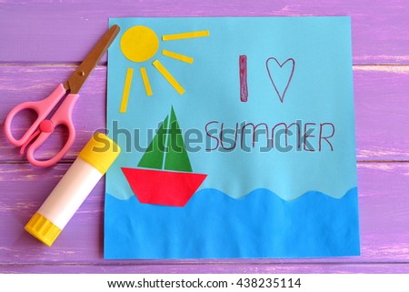 Colorful paper card with ship, sea, sun and words I love summer. Scissors and glue stick on lilac wooden background. Preschool and kindergarten paper crafts. Summer fun background.