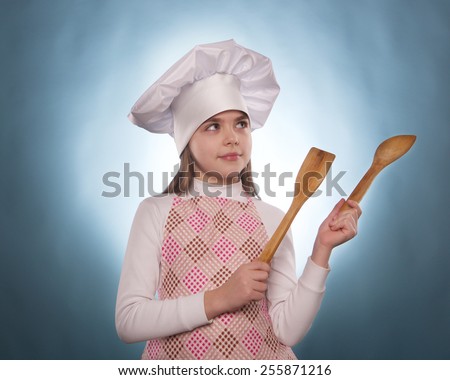 the girl with chef hat indicates isolated on the blue background