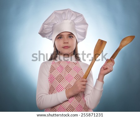 the girl with chef hat indicates isolated on the blue background