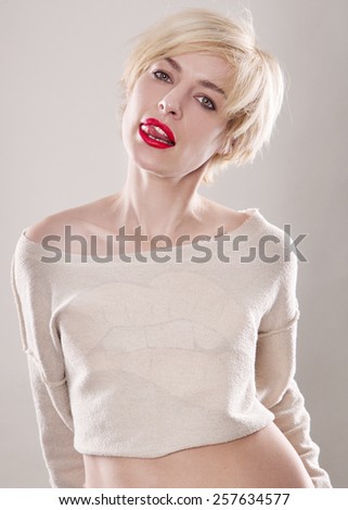the blond woman with short hair and a beautiful smile with red lips isolated on the white background