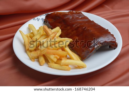 roasted pork ribs in the glaze with potatoes