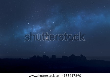 Starry night sky background above the city landscape