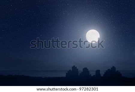 Full moon and starry sky over the city