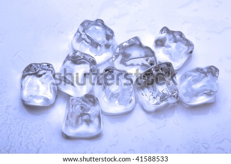 group of ice cubes with melted water around