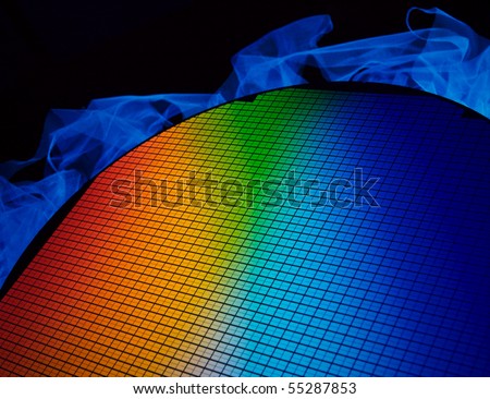 detail of a silicon chip wafer reflecting different colors