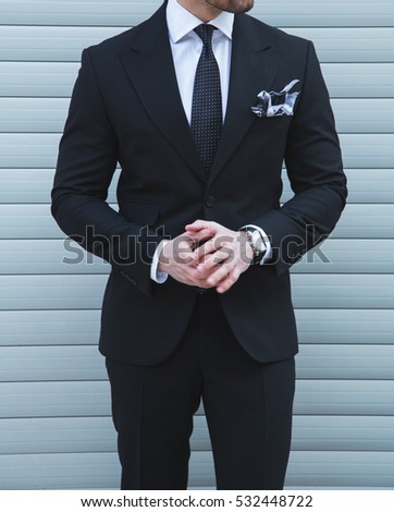 Male model posing in a black suit