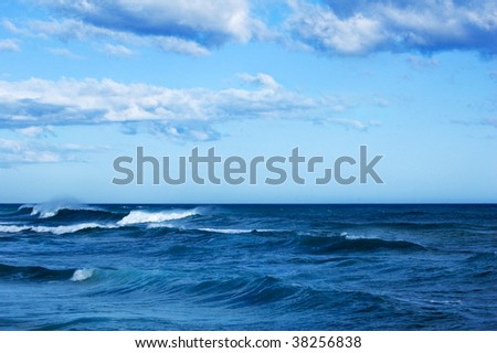A rough ocean under a blue sky