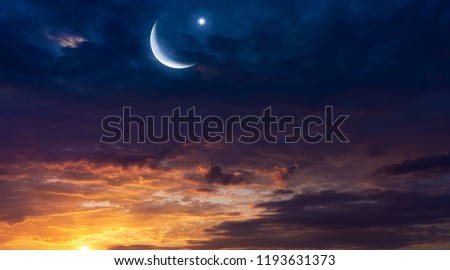 Crescent moon with beautiful sunset background .  Light from sky . Religion background . beautiful sky . Yellow and pink clouds . Sunset and new moon . Prayer time . Generous Ramadan