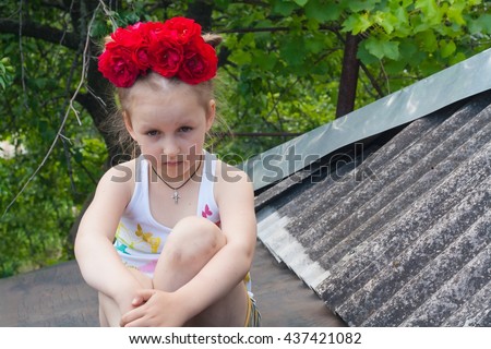 Stubborn character . Child in the fresh air .  Happy childhood. Cheerful girl. ht clothes. Bring Emotions of happiness and pleasure . Clothes in peas . Active child. To climb on a roof.