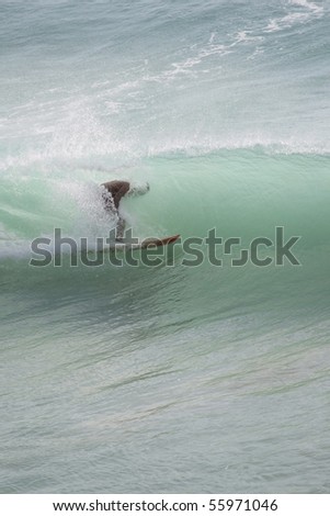 The person floating at ocean on a surfboard