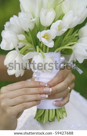 Beautiful wedding bouquet in gentle hands of the bride