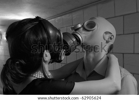 Artly processed it is black a white photo of the Loving couple in gas masks kisses in transition