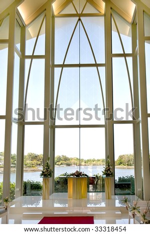 stock photo Modern wedding chapel with view through glass windows at lake