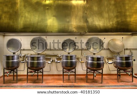 View of the old cooking pots in a disused prison kitchen