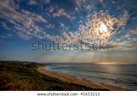 View of a dramatic cloudscape over a deserted beach. High dynamic range (HDR) image.