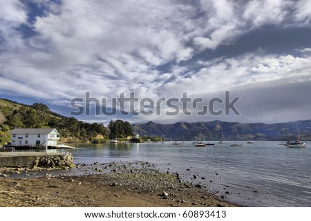View of Akaroa Bay, New Zealand, with mountain ranges in background. High Dynamic Range image.