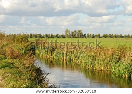 Landscape with water, grass and clouds