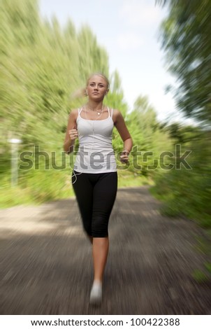 Girl with a music player running on the road