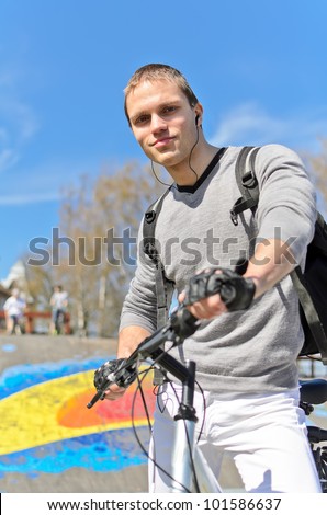 Portrait of BMX bicycle rider on urban skatepark background