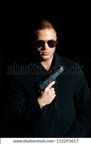 Portrait of young man with gun