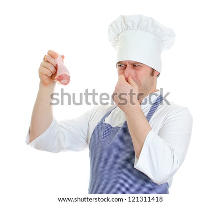 Chef cook holding rotten chicken leg. Isolated on white - stock photo