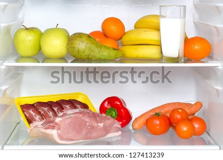 Open fridge full of fruits, vegetables and meat