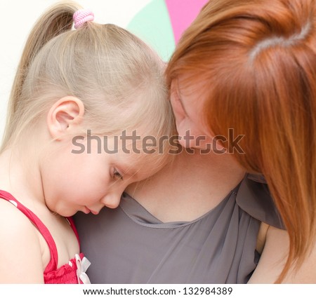 Mother hugging her sad child