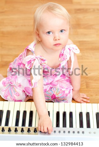 Little girl and playing the piano