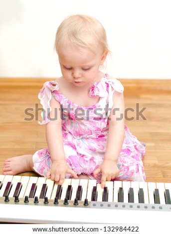 Little girl and playing the piano