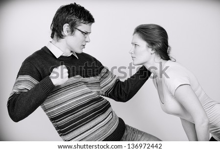 Man going to beat his wife. Home violence concept. Black and white