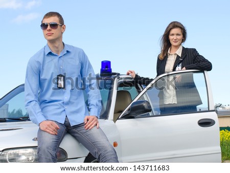 Two FBI agents near the car with flasher