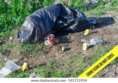 Crime scene with male corpse and evidence markers