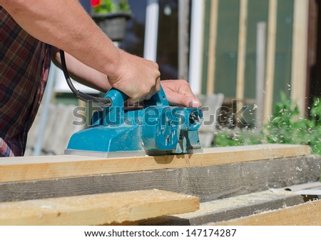 Handyman using polish machine outdoors