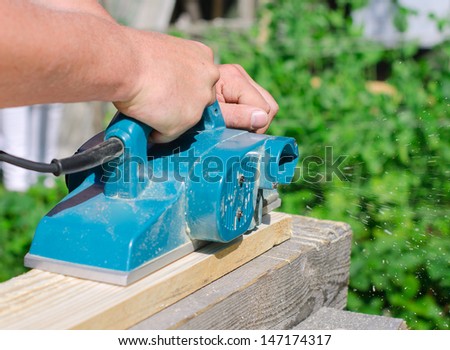 Handyman using polish machine outdoors