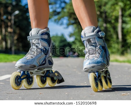 Close-up view of female legs in roller blades