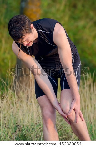 Sportsman holding his leg. Sports injury concept.