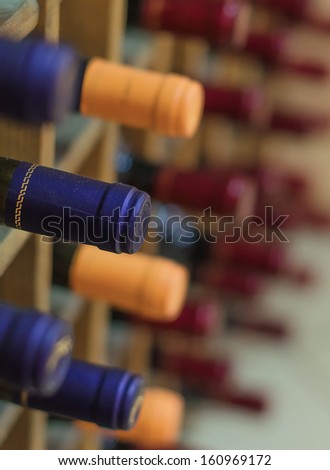 Different wine bottles stacked on wooden racks
