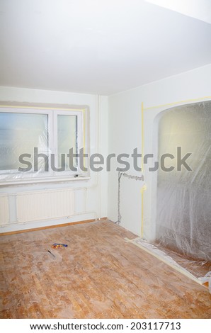 Room renovation. White room repair with dirty floor.