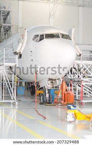 Passenger plane in the hangar. Aircraft maintenance.