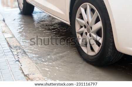 Car during heavy rain in the city.