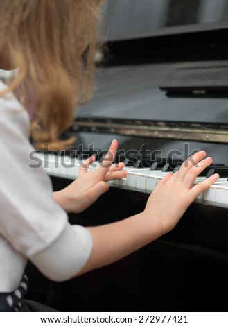 Child learns to play the piano.