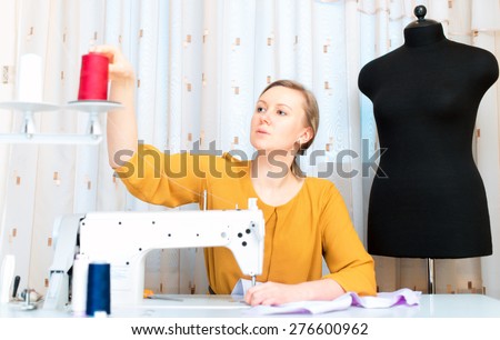 Woman working on sewing machine in the factory.