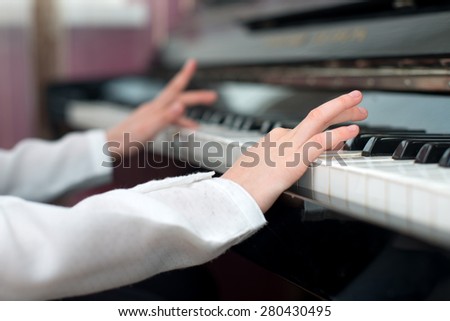 Child learning to play the piano.